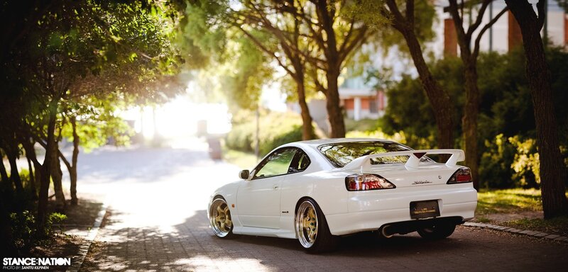 White Nissan Silvia on a tree-lined street