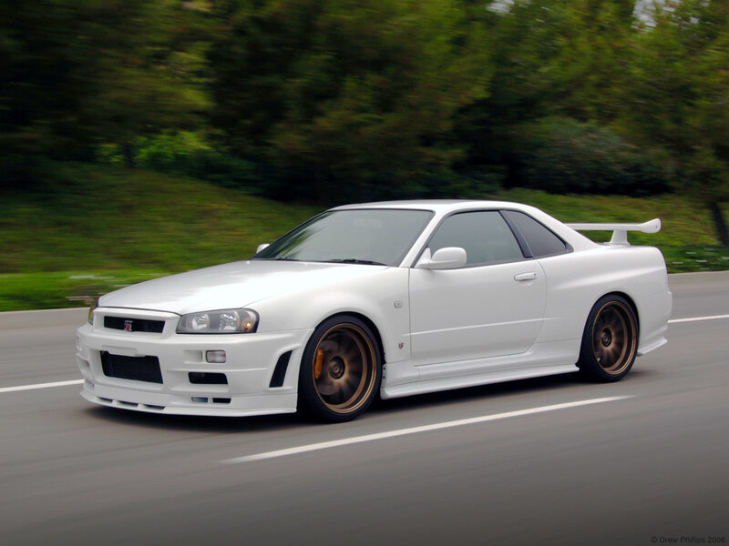 white nissan skyline in motion