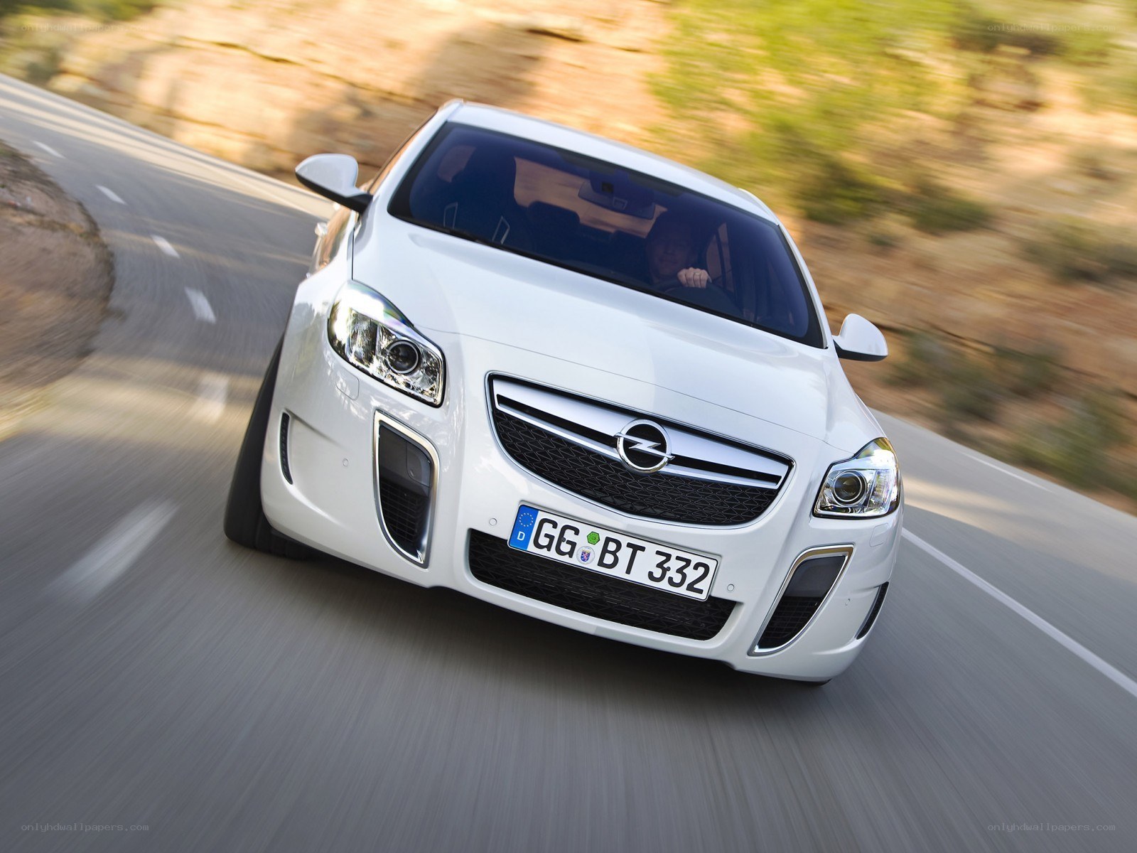 white opel on a winding road