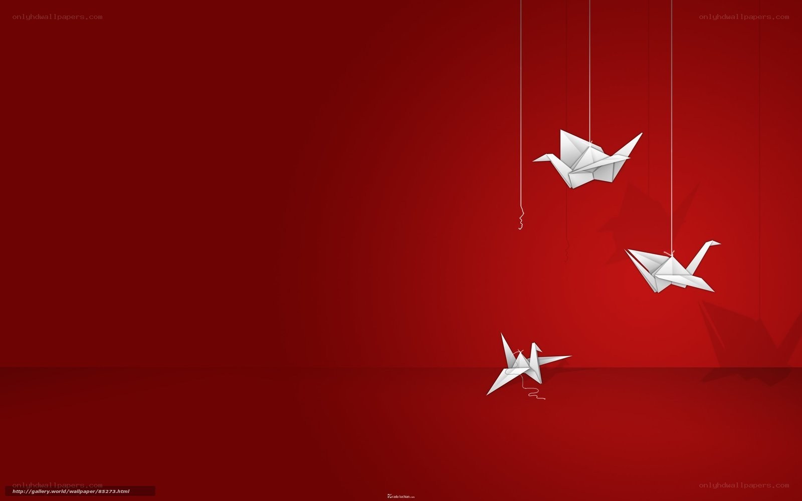 White origami cranes on red