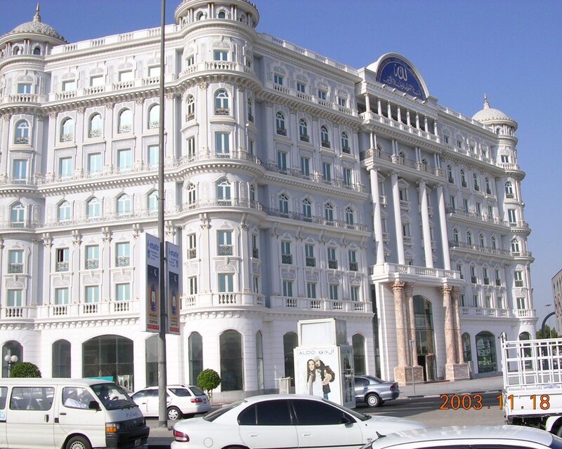 White ornate building with cars