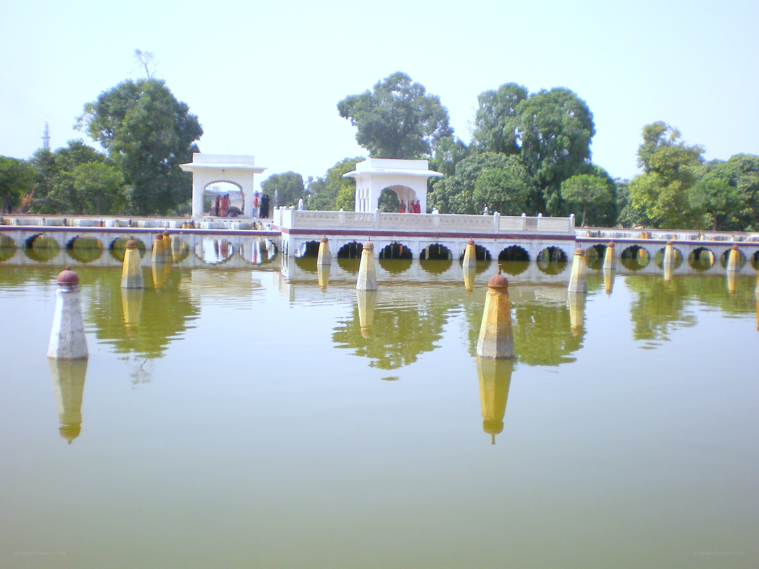 White pavilions over a pond