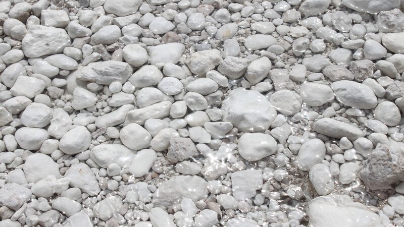 white pebbles in shallow water