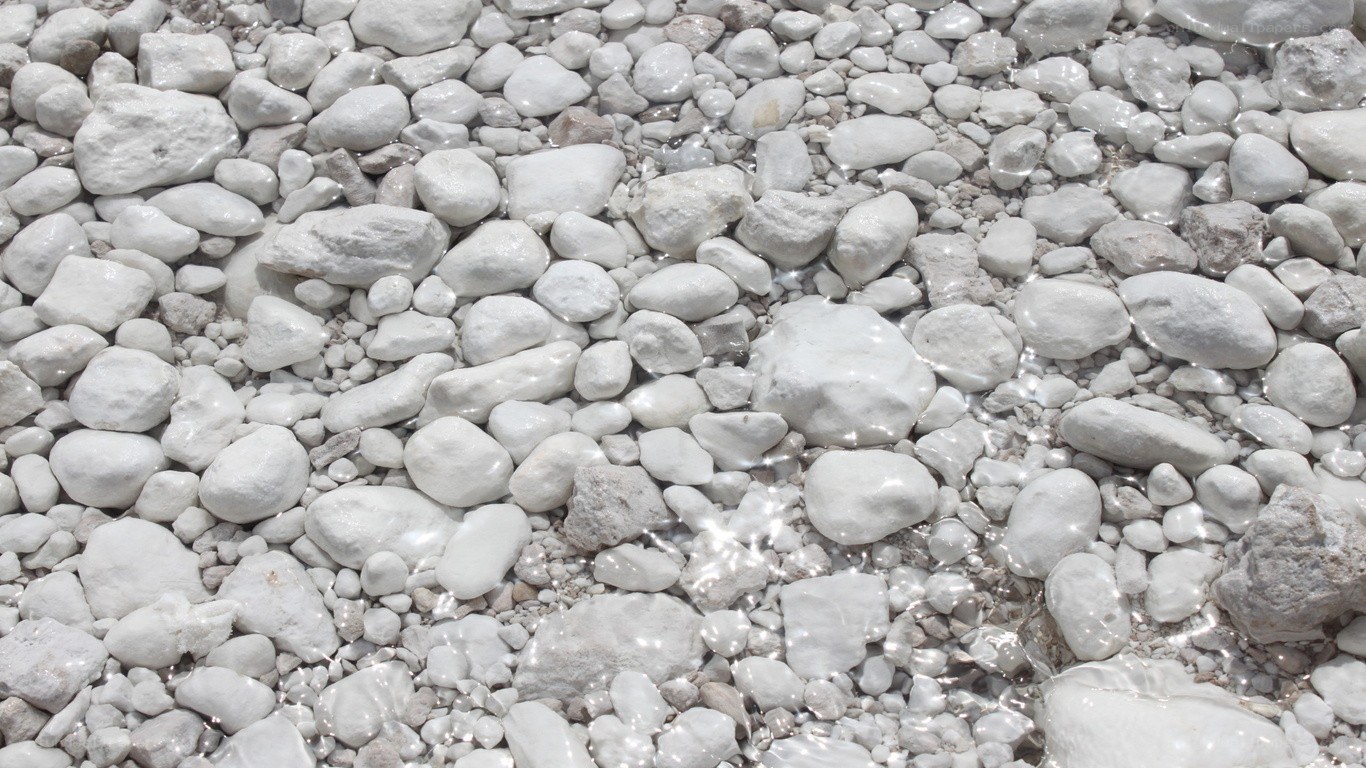 white pebbles in shallow water