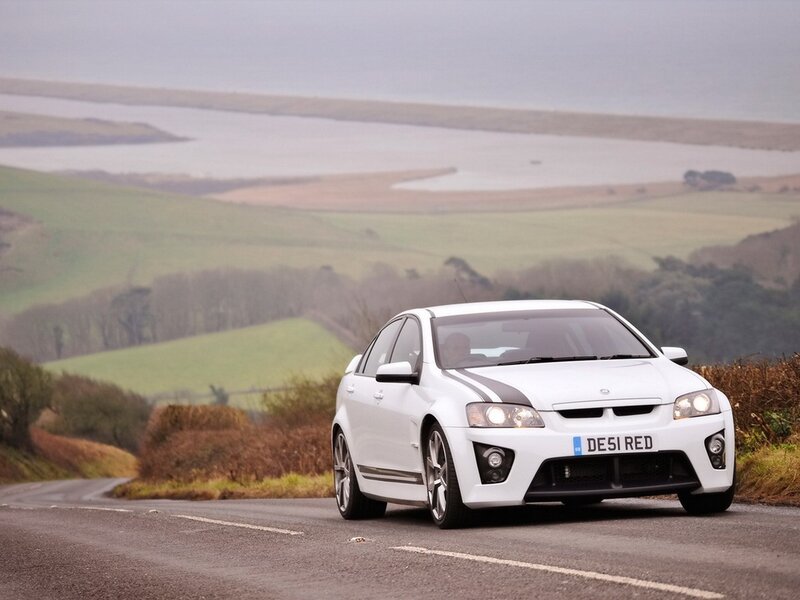 white performance car on country road