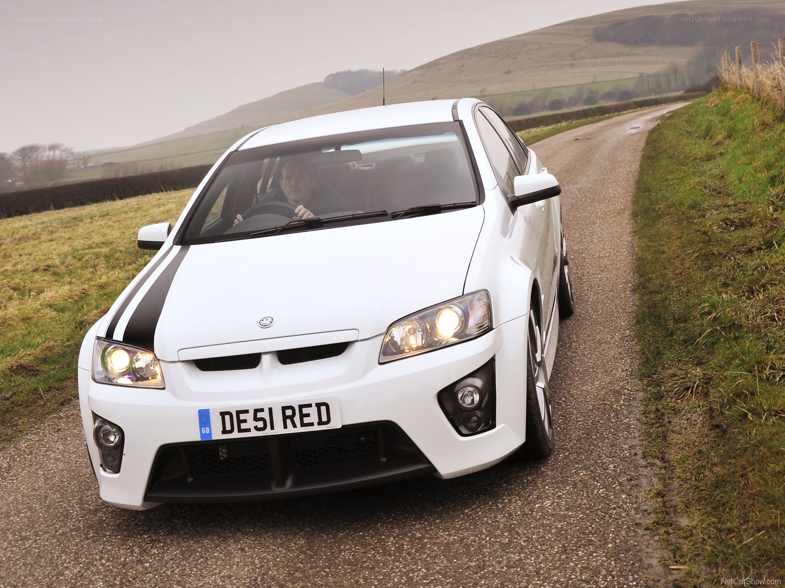 white performance car on country road