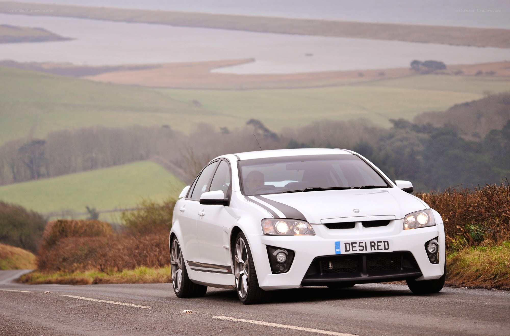 white performance car on country road