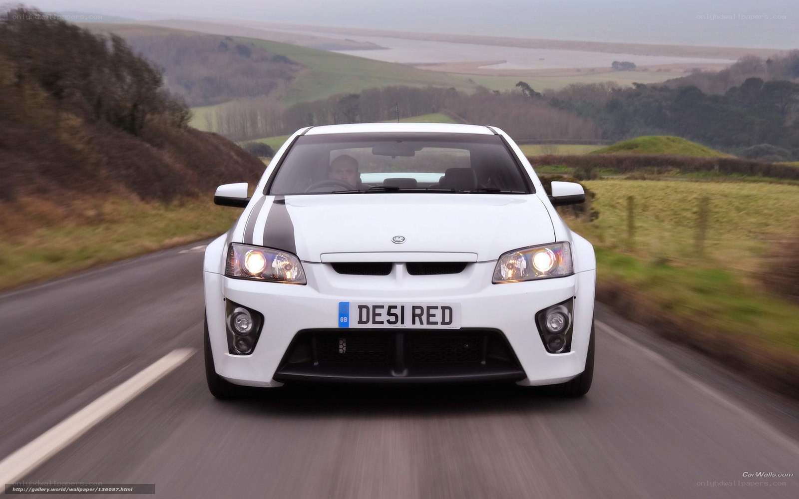 white performance car on country road