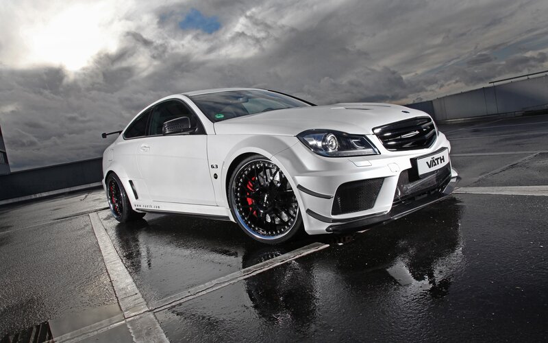 white performance coupe on wet pavement