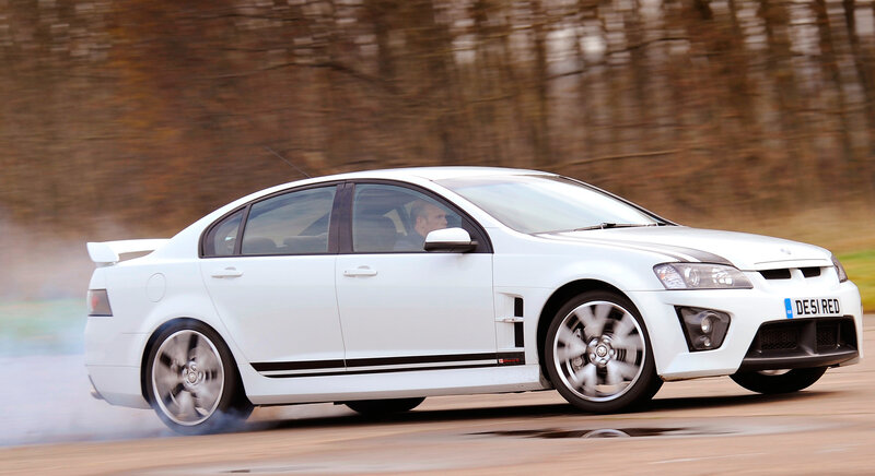 white performance sedan drifting