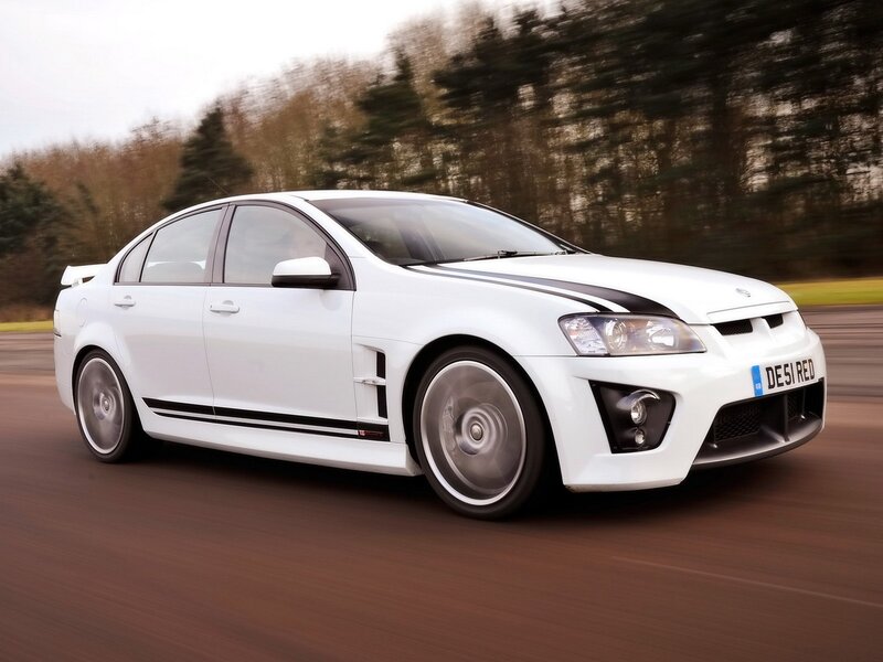 white performance sedan in motion