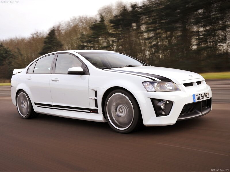 white performance sedan in motion