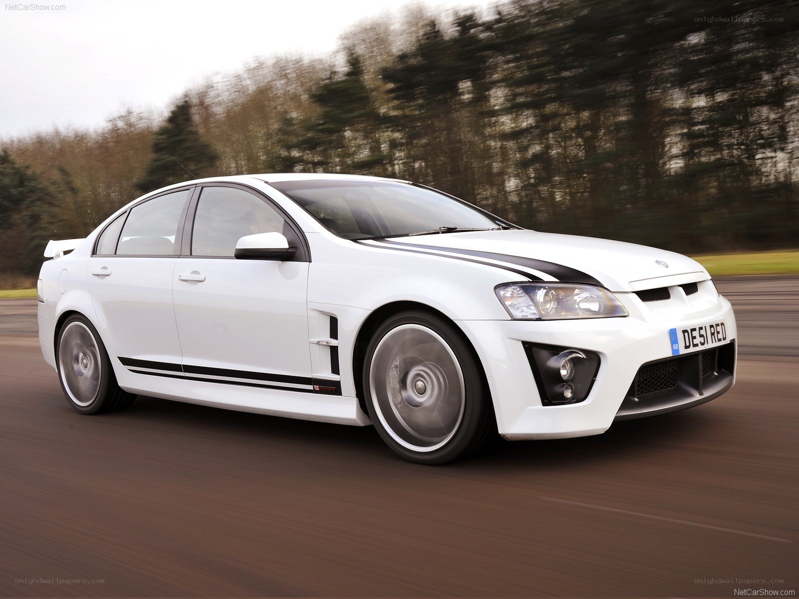 white performance sedan in motion
