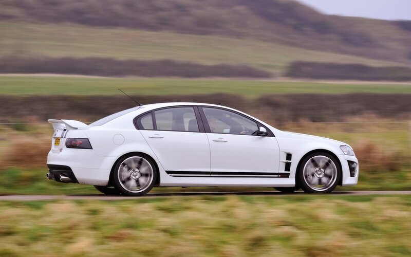 white performance sedan in motion