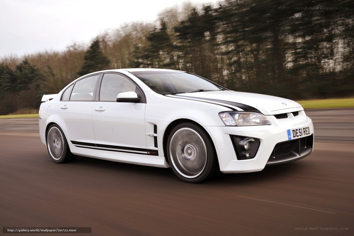 white performance sedan in motion