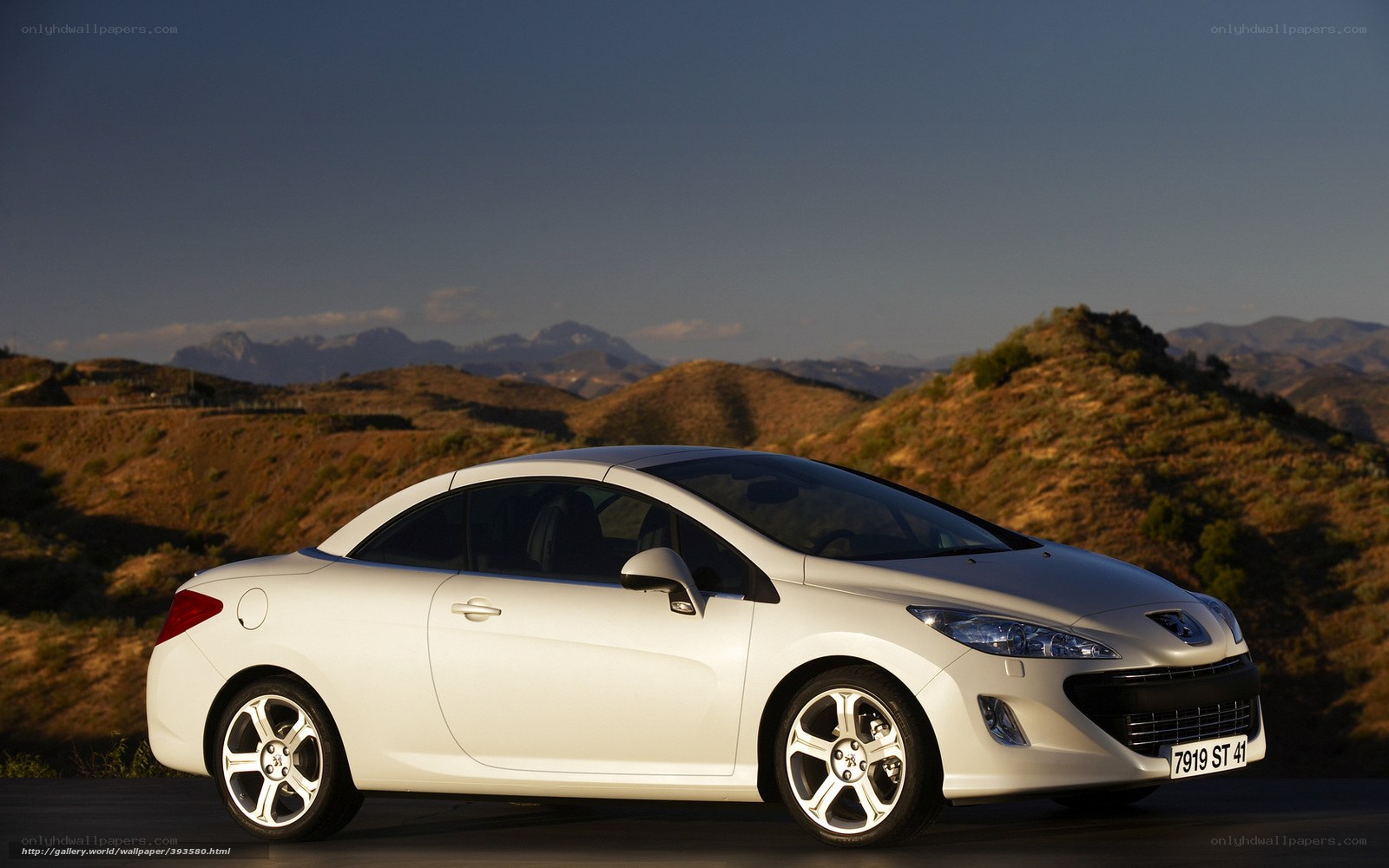 White Peugeot 308 CC on a mountain road