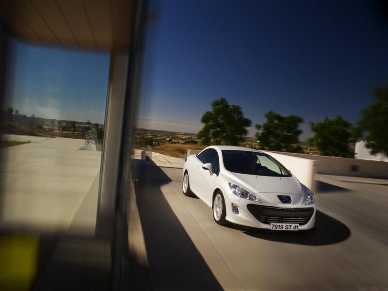 White Peugeot car on a road