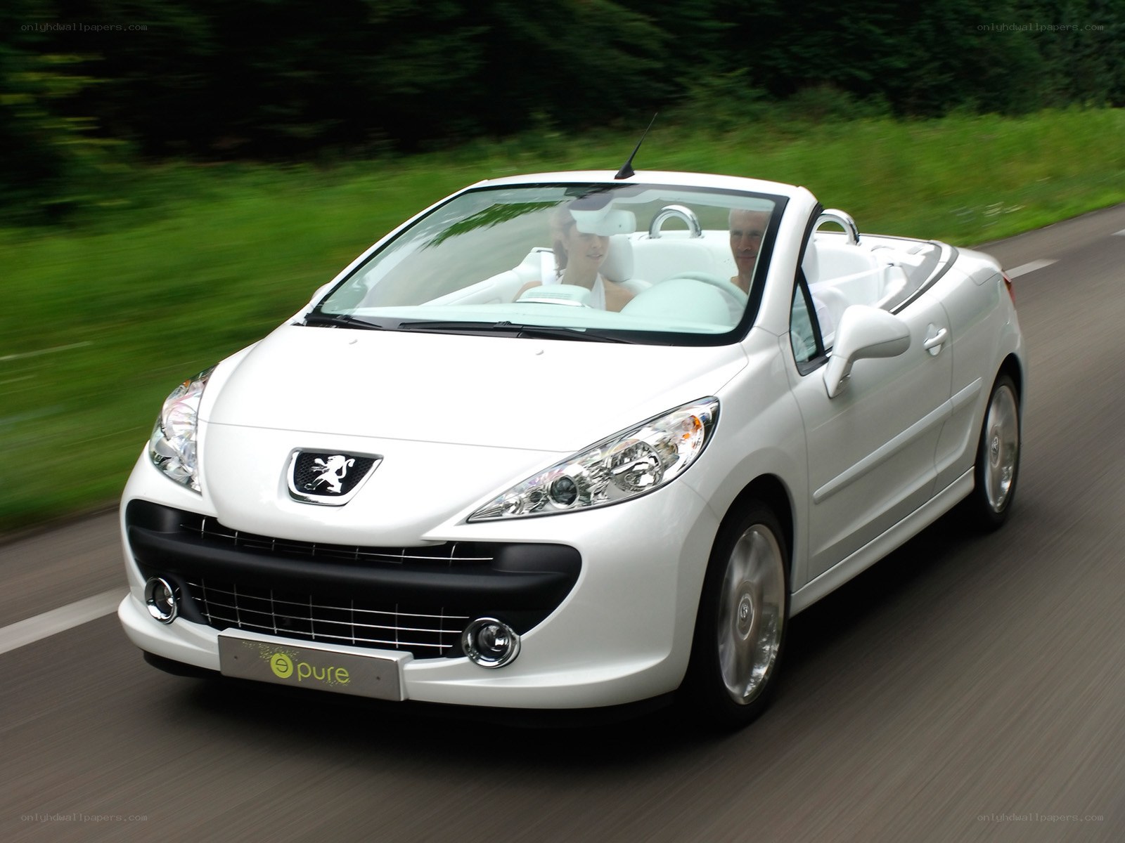 White Peugeot convertible on road