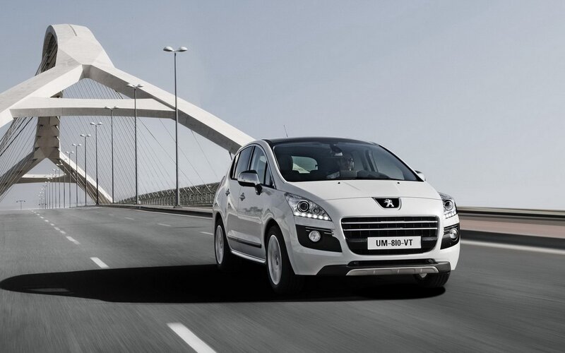 White Peugeot driving on a bridge