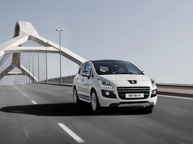 White Peugeot driving on a bridge