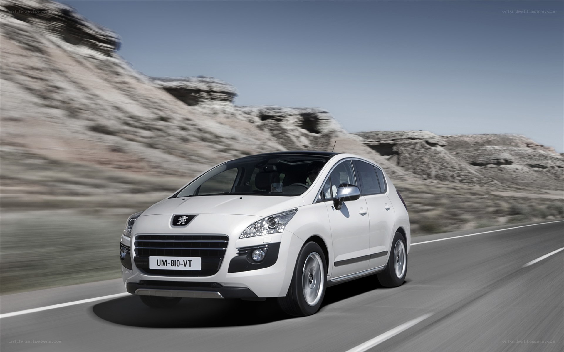 White Peugeot driving on a road