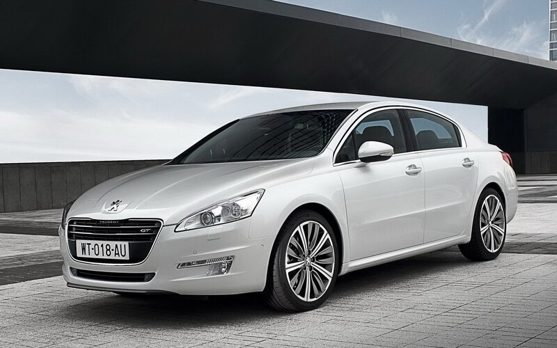 White Peugeot sedan parked