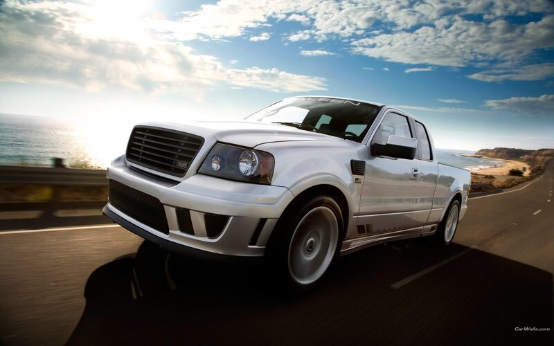 white pickup truck on coastal road