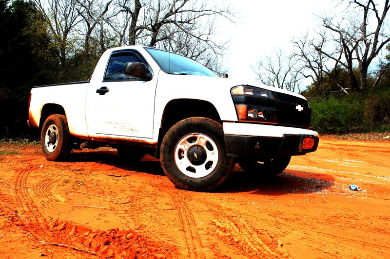 white pickup truck on dirt road