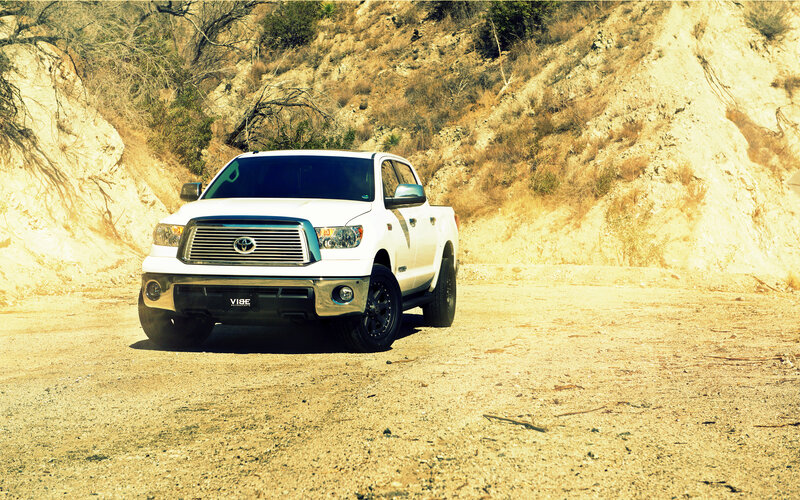 White pickup truck on dirt road