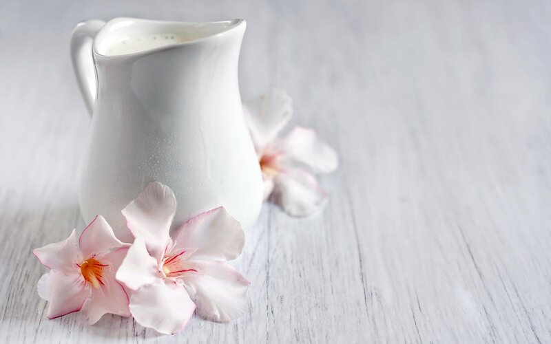 White Pitcher with Flowers — Serene, Photograph, Wooden Surface