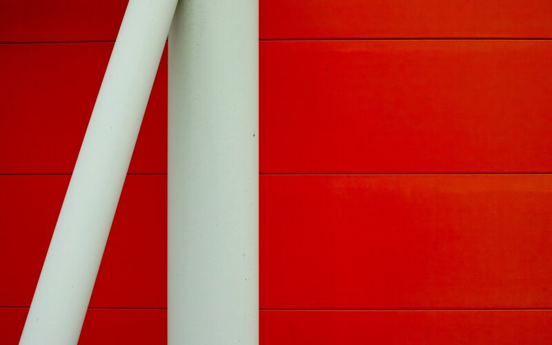 White Poles on Red Wall