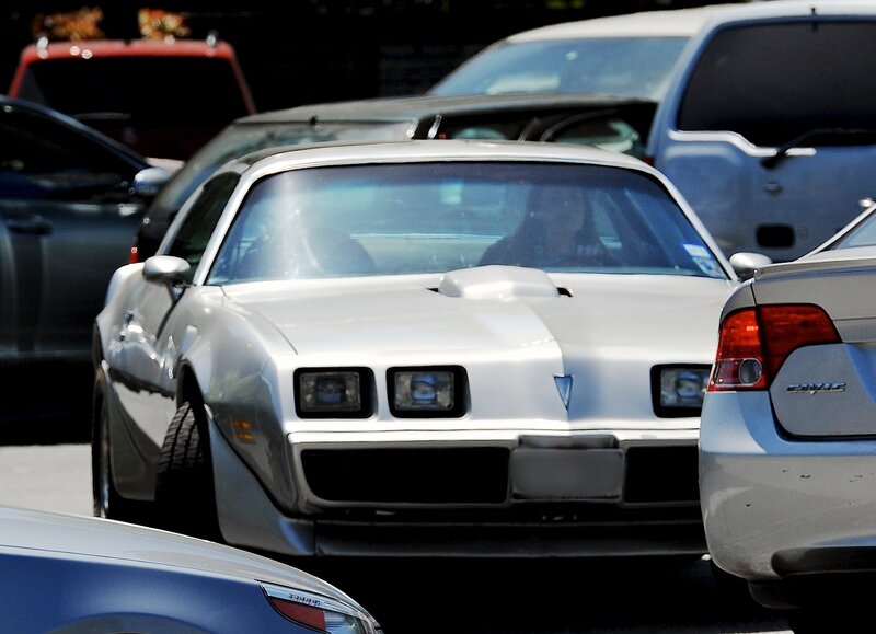 white pontiac firebird in traffic