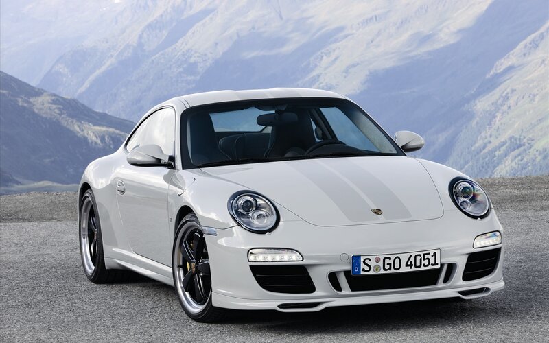 White Porsche 911 on mountain road