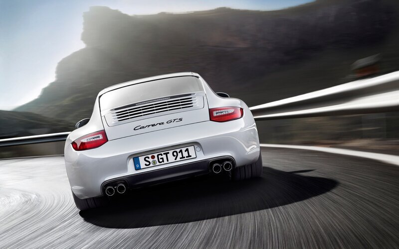White Porsche Carrera GTS in motion