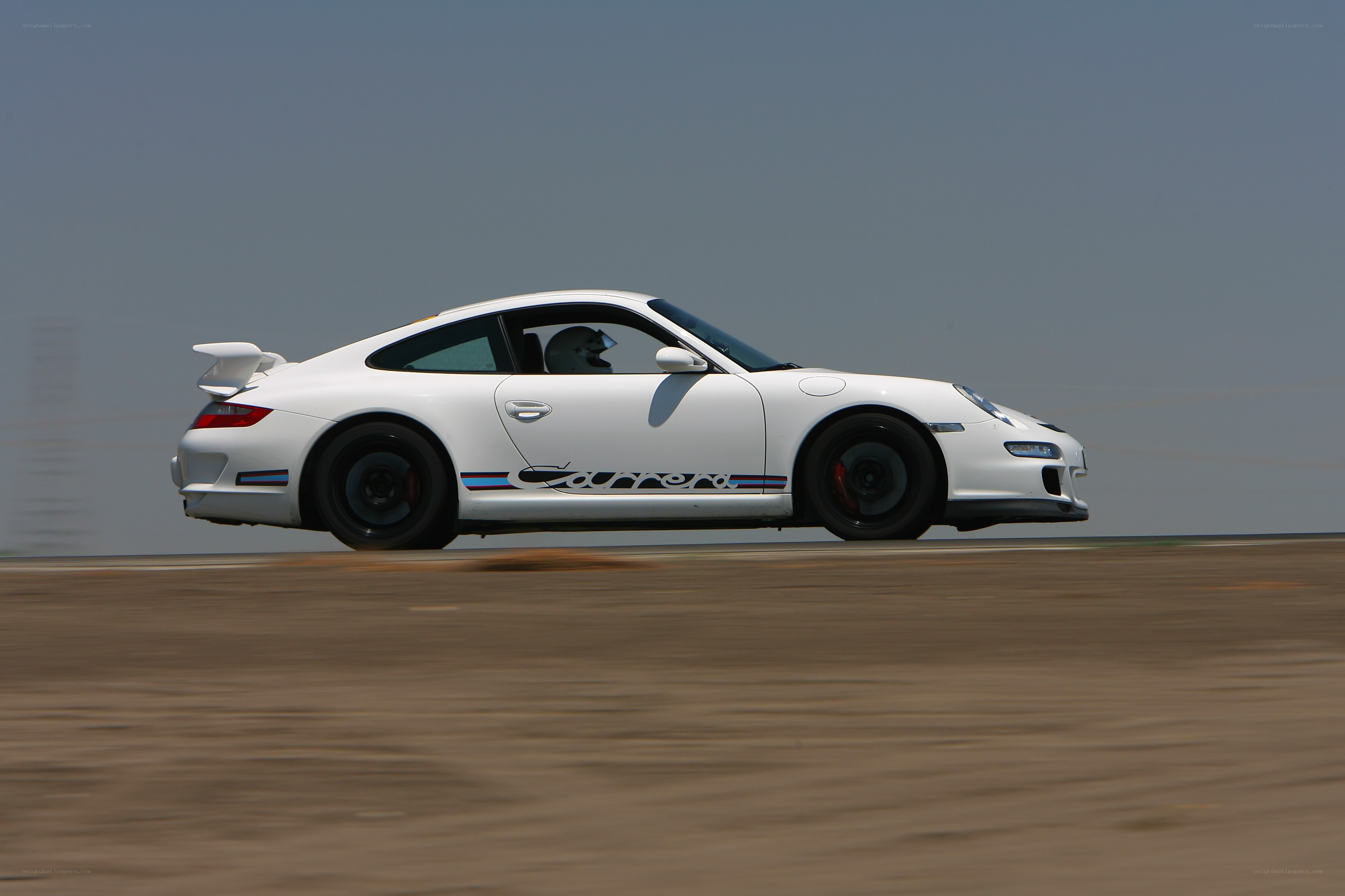 white porsche carrera on track