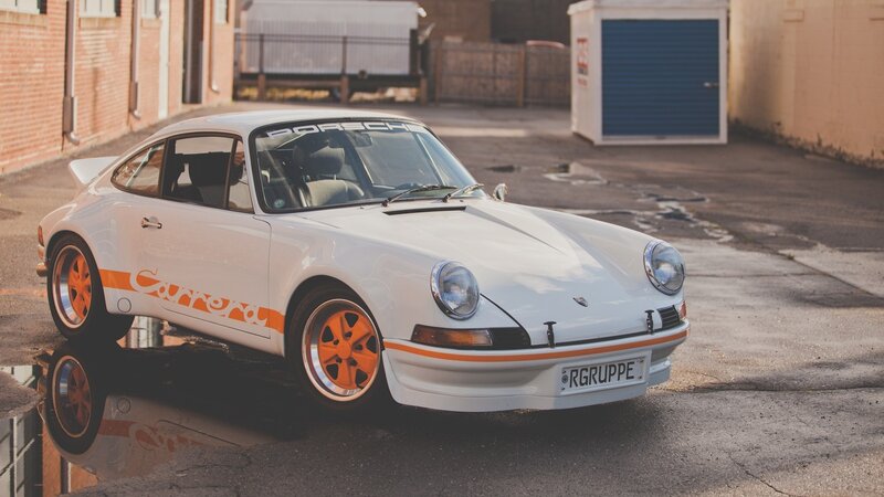 White Porsche Carrera with orange accents