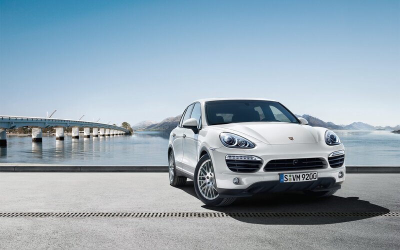 White Porsche Cayenne by a lake