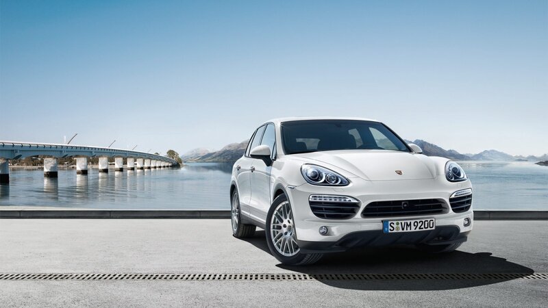 White Porsche Cayenne by a lake