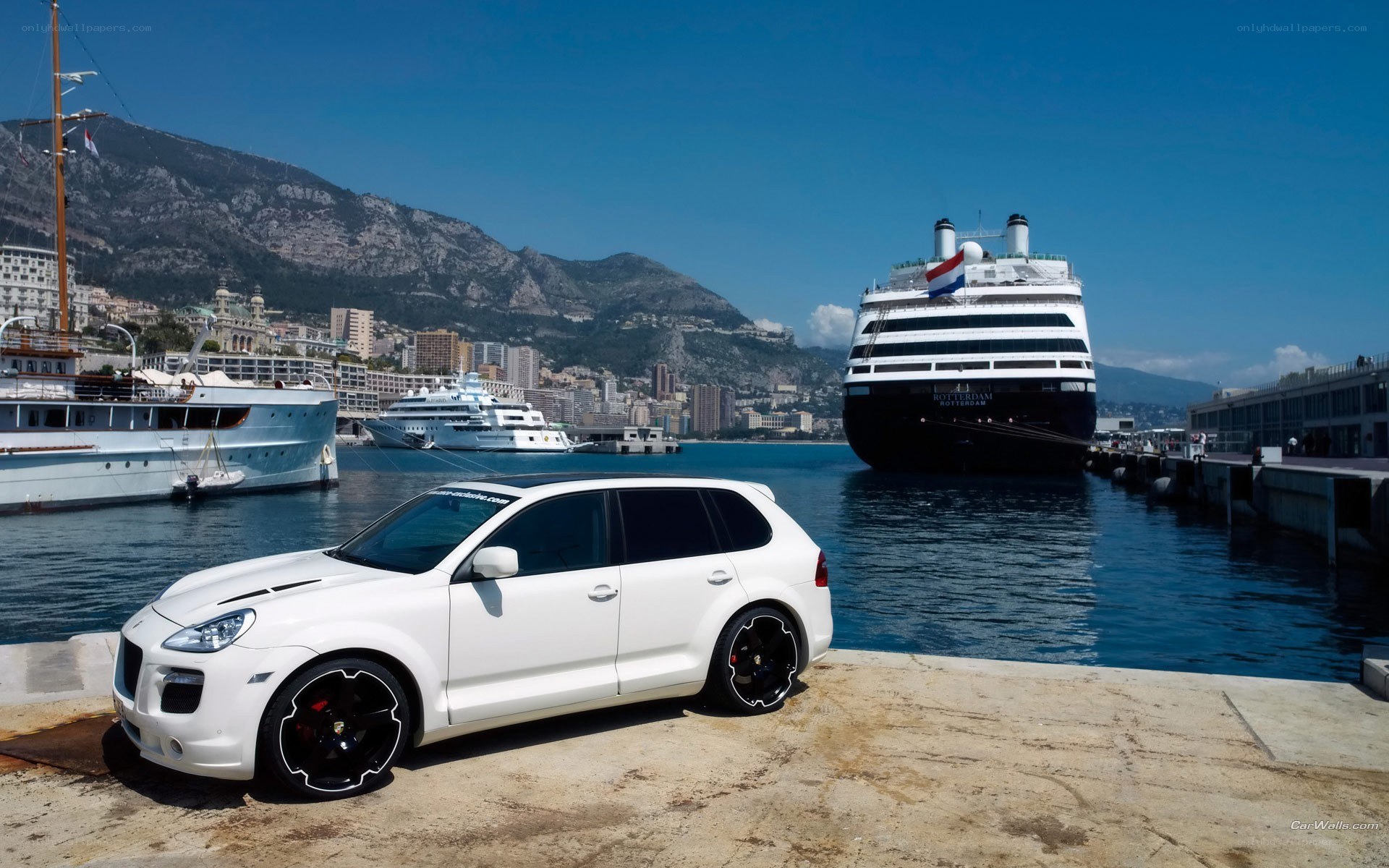 White Porsche Cayenne by the harbor