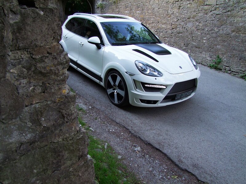 White Porsche Cayenne on a stone road