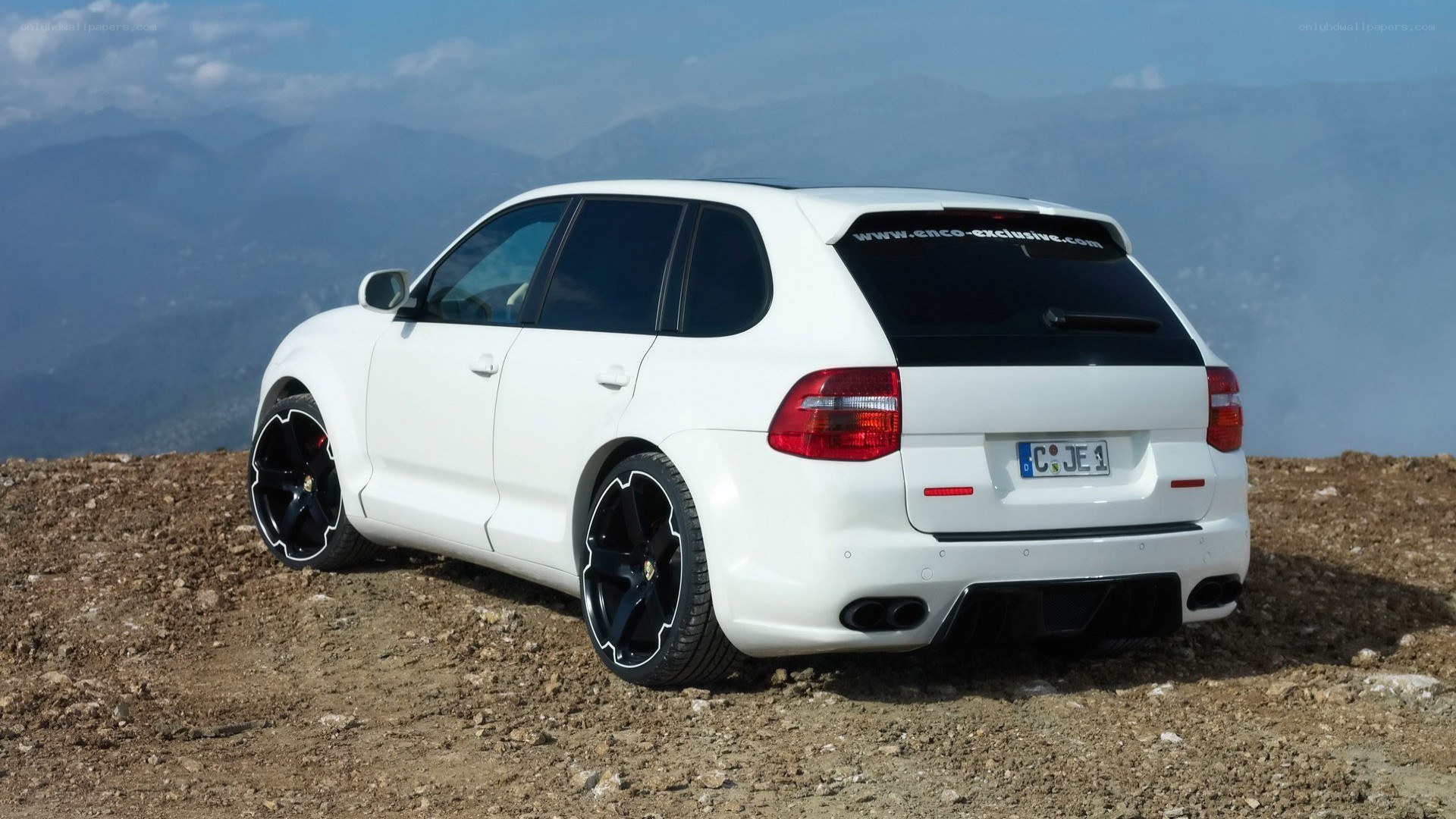 White Porsche Cayenne on mountain