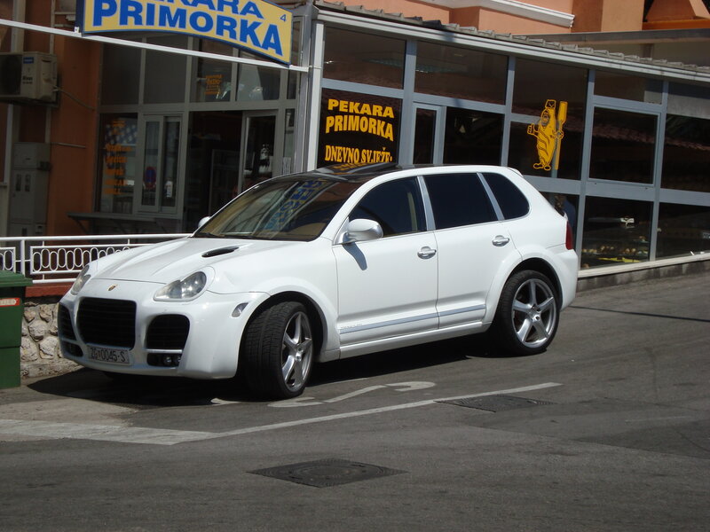 White Porsche Cayenne parked outside
