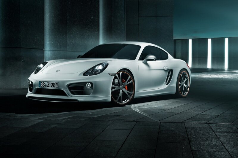 White Porsche Cayman in a dark garage