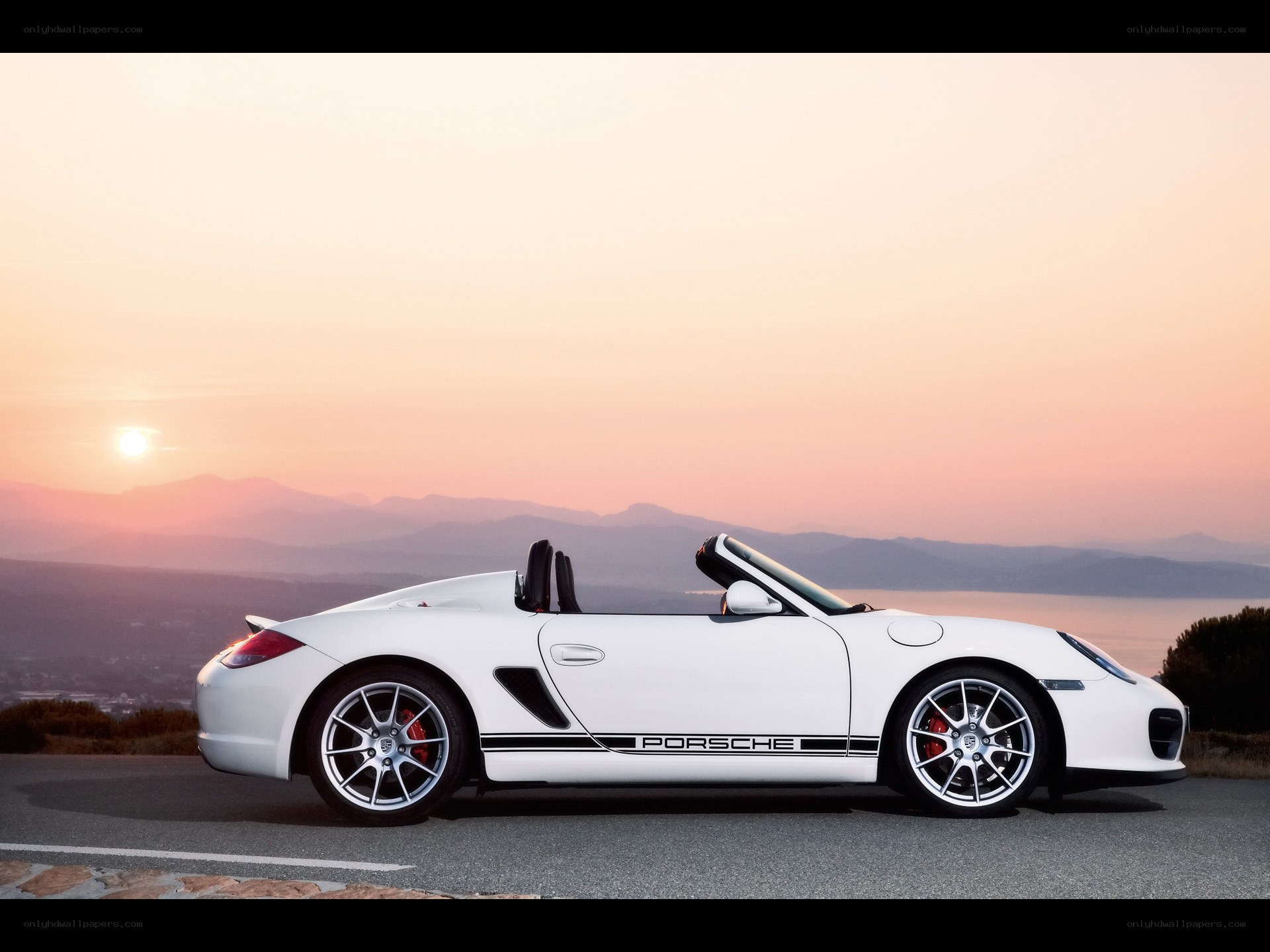 White Porsche convertible at sunset