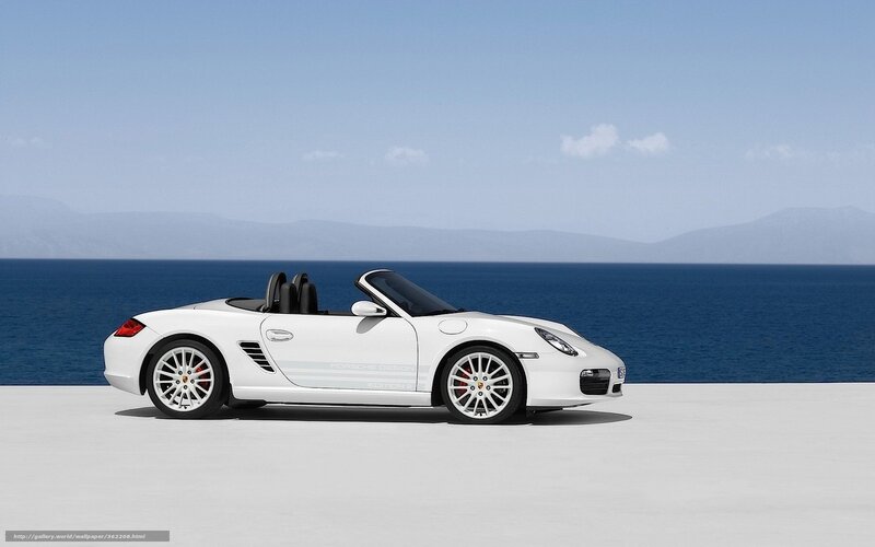 White Porsche convertible by the sea