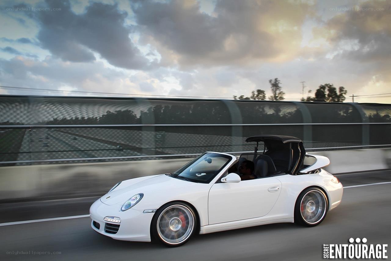 White Porsche convertible in motion