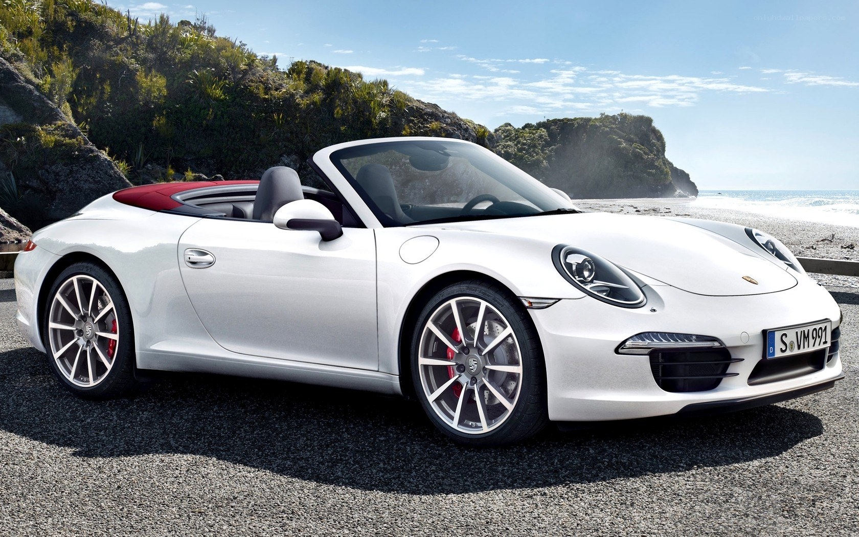 White Porsche convertible on beach