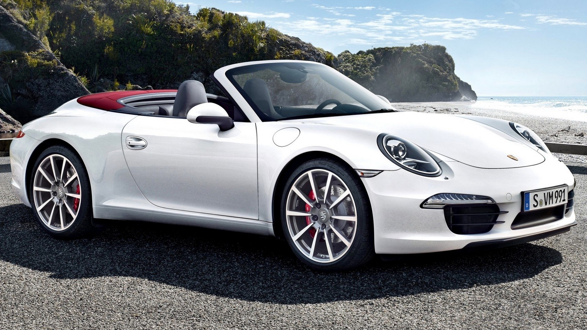 White Porsche convertible on beach