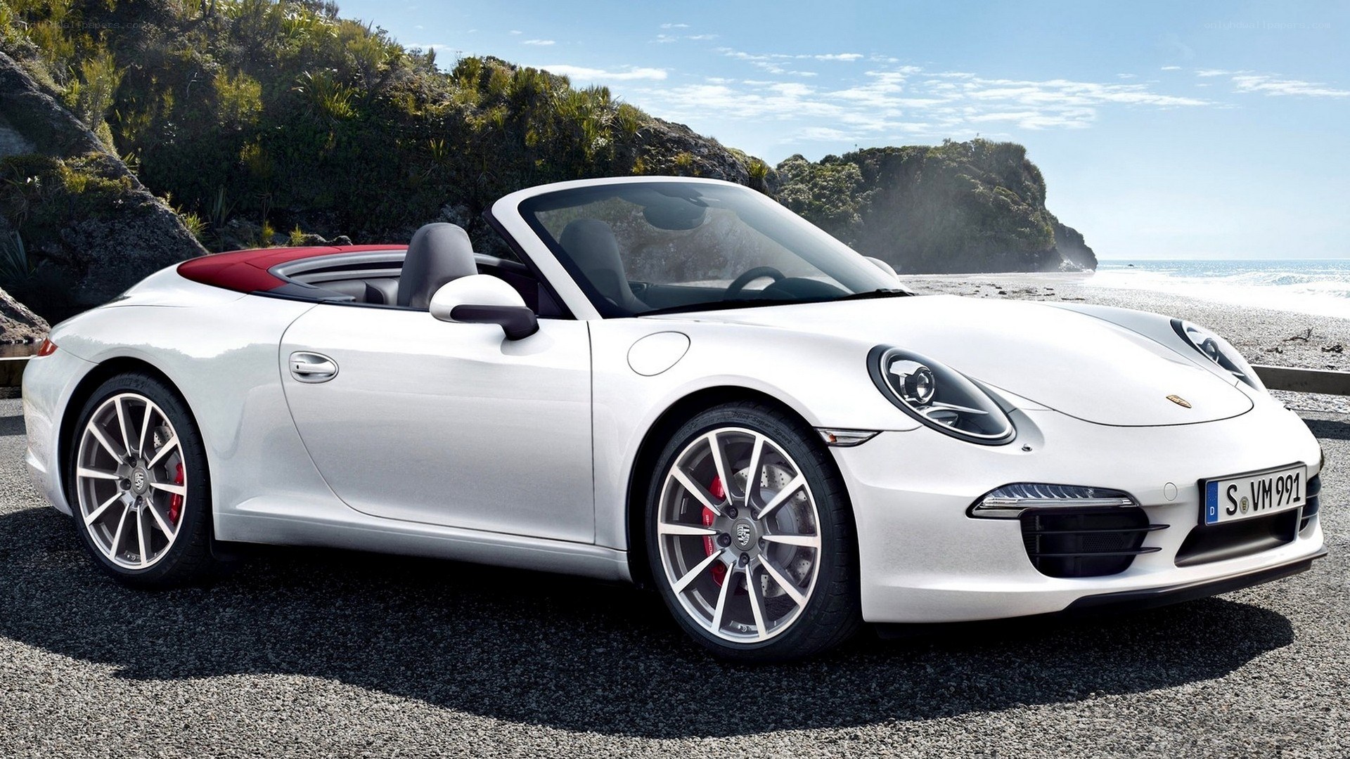 White Porsche convertible on beach
