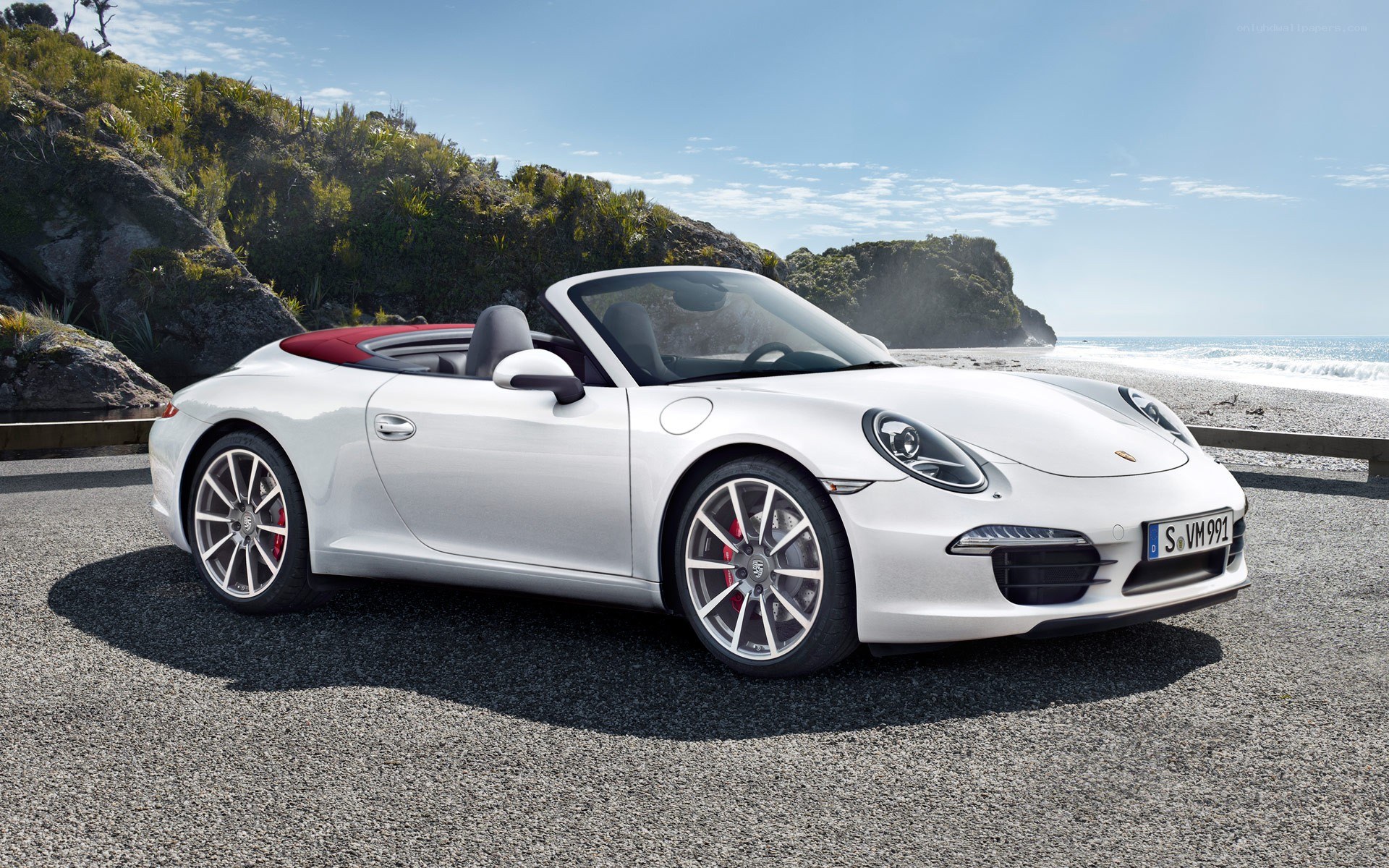 White Porsche convertible on beach